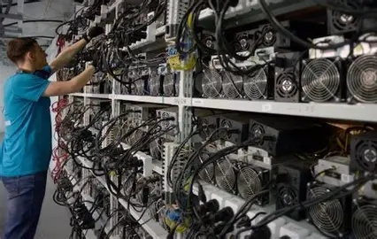Cryptocurrency mining farm with rows of mining machines operating under advanced cooling infrastructure